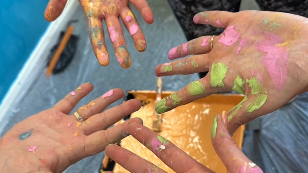 Hands covered in paint